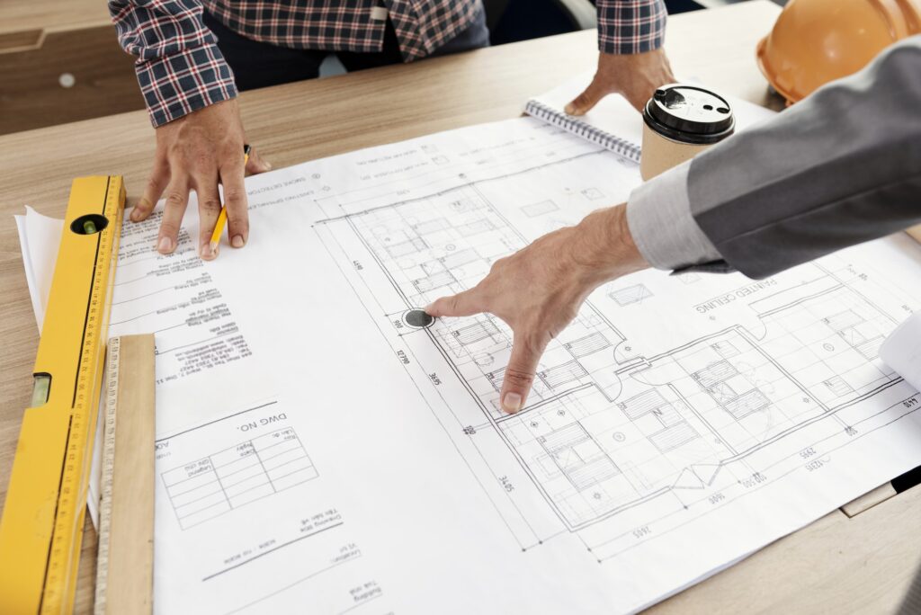 People examining construction blueprint